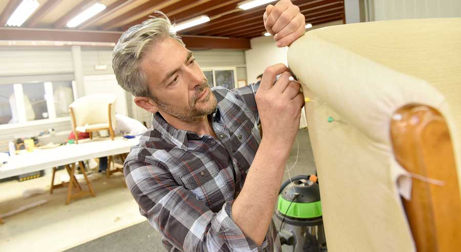 Man-working-in-upholstery-shop