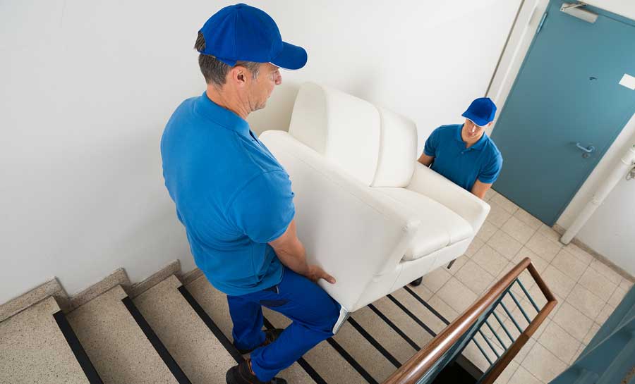 Two movers delivering sofa